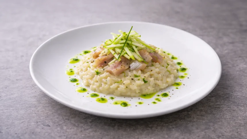 Risotto al parmigiano all’onda con aringa affumicata, julienne di mela verde e olio all’erba cipollina